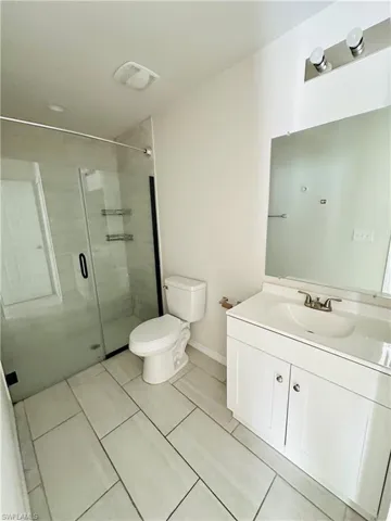 Full bath with vanity and a stall shower