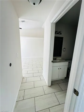 Hall with light tile patterned floors