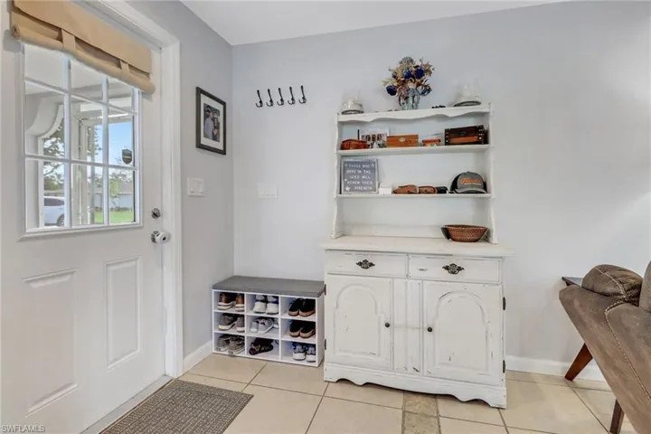 Doorway featuring light tile patterned floors