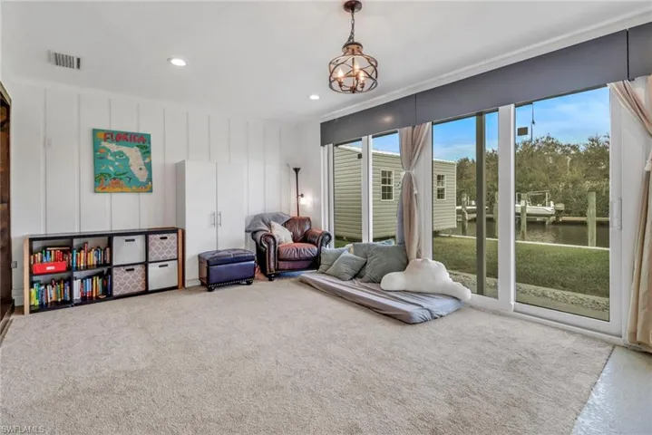 Living area featuring an inviting chandelier and a water view