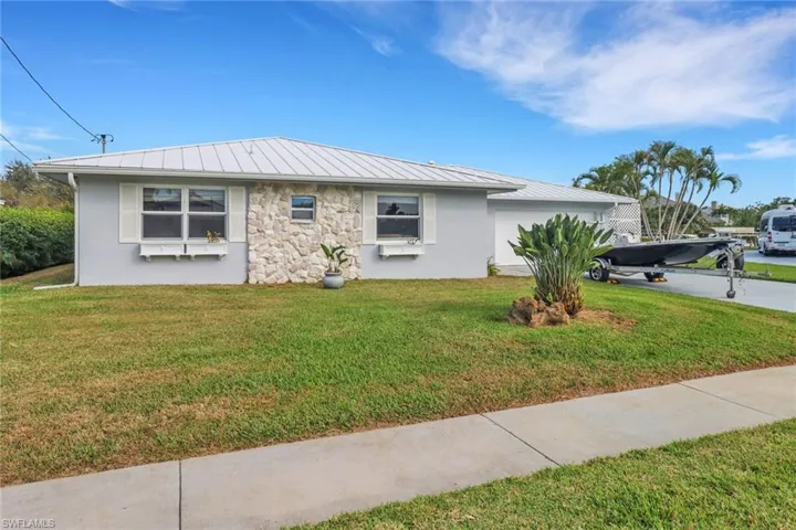 View of side of home with a yard