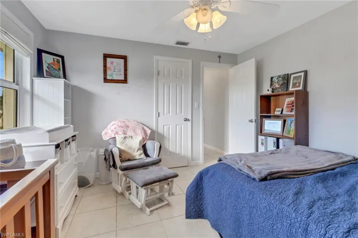 Bedroom featuring light tile patterned flooring and ceiling fan