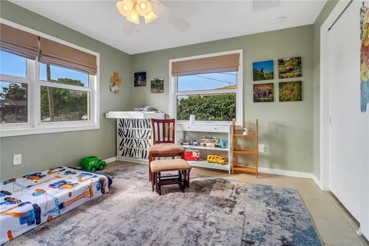 Bedroom featuring ceiling fan and light tile patterned flooring