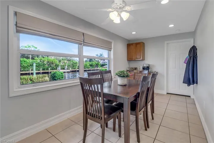 Tiled dining area featuring ceiling fan