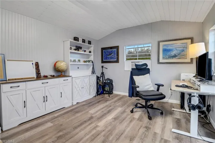 Home office featuring light hardwood / wood-style flooring, wood ceiling, and vaulted ceiling