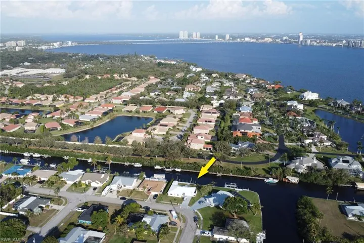 Birds eye view of property with a water view