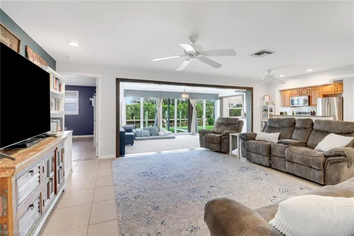 Tiled living room featuring ceiling fan