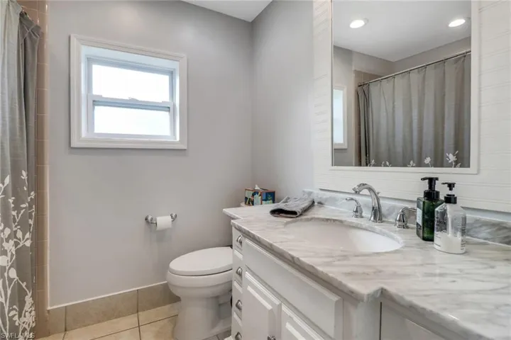 Bathroom with tile patterned flooring, vanity, and toilet