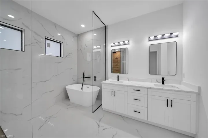 Dual vanity with white cabinetry and integrated sinks