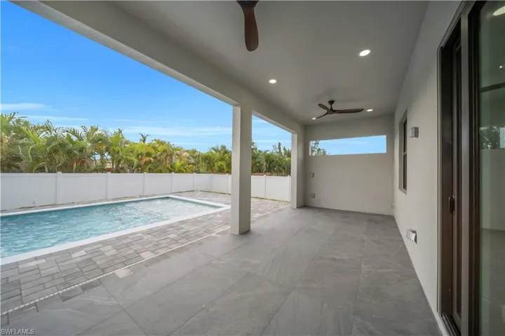 Covered patio with recessed lighting and ceiling fans