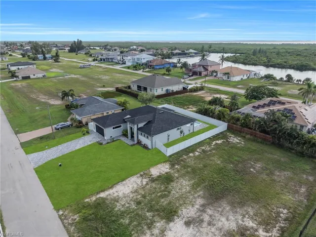 Contemporary exterior with a dark shingle roof, paver driveway, and a fenced backyard