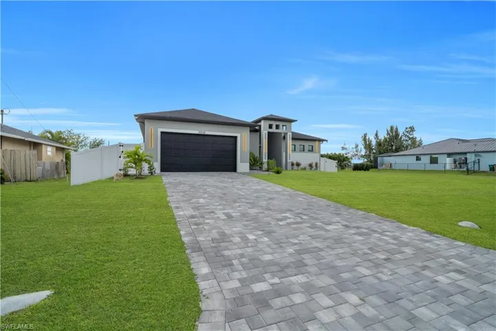 Contemporary stucco exterior with a prominent two-story entry and an integrated garage