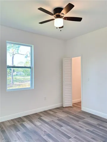 Empty room featuring light wood-style floors and ceiling fan