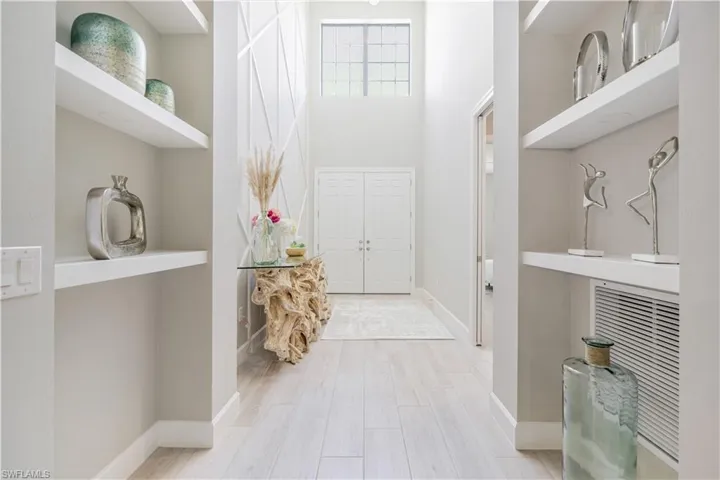Foyer featuring light wood-style floors and a high ceiling