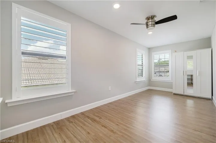 Empty room with light wood-style floors, recessed lighting, and ceiling fan