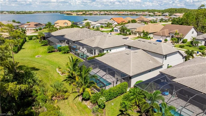 Aerial perspective of suburban area featuring a nearby body of water