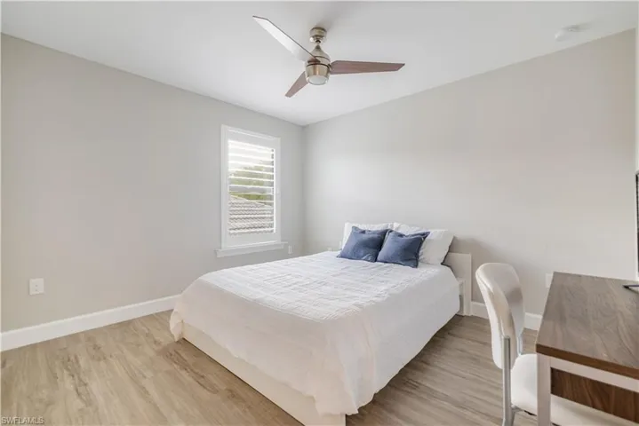 Bedroom featuring wood finished floors and a ceiling fan