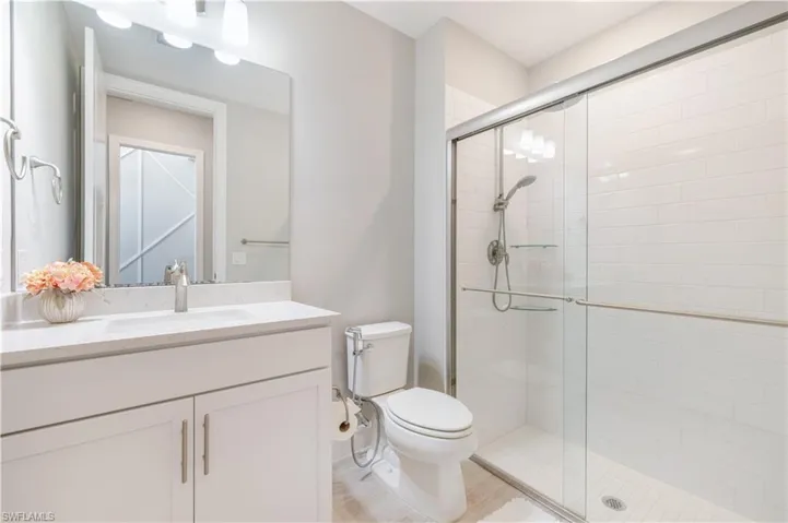 Bathroom featuring a shower stall and vanity