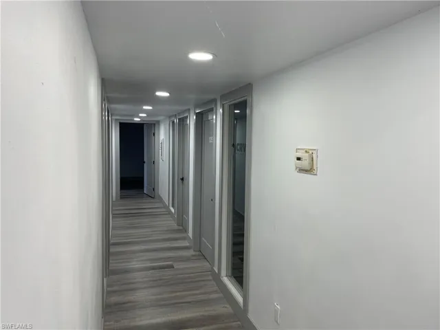Corridor with recessed lighting and dark wood-style floors