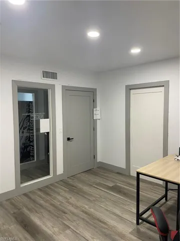 Hallway featuring light wood-type flooring and recessed lighting