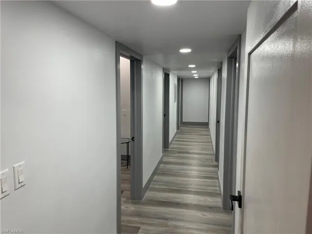 Hallway featuring dark wood finished floors and recessed lighting