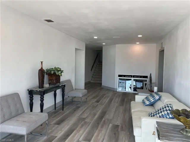 Living room with wood finished floors and recessed lighting