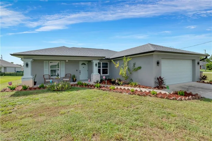 Ranch-style home with a garage and a front yard