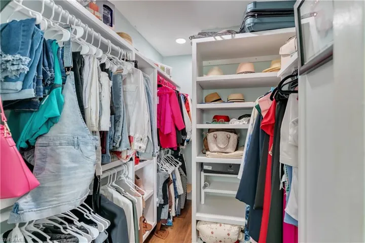 Spacious closet  in the master with hardwood / wood-style floors