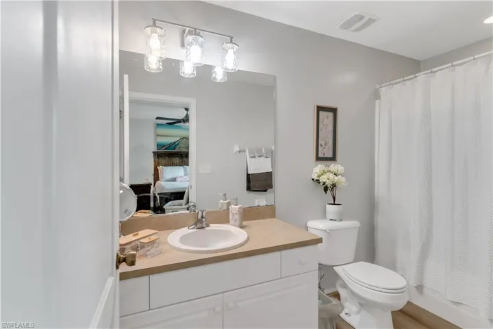Master Bathroom with ceiling fan, vanity, and toilet