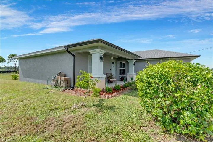 View of property exterior with a lawn