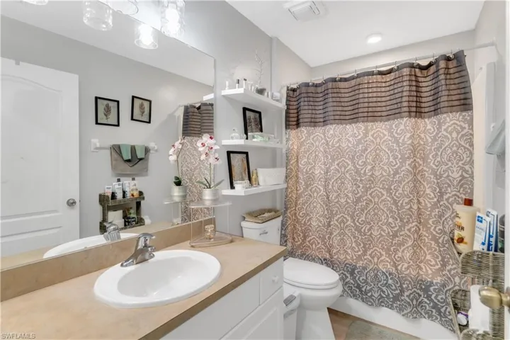 Full bathroom featuring toilet, vanity, and shower / bath combo