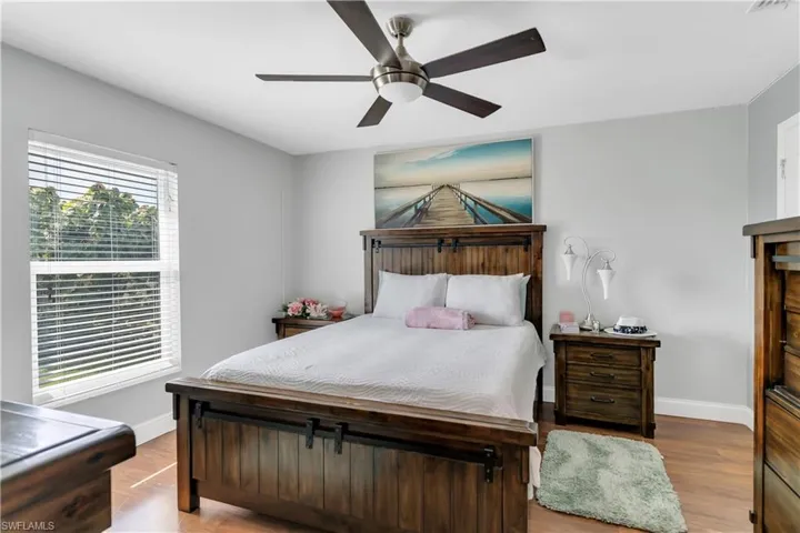 Master Bedroom with ceiling fan and light wood-type flooring