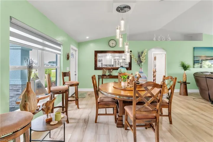 Dining area featuring lofted ceiling and light hardwood / wood-style floors