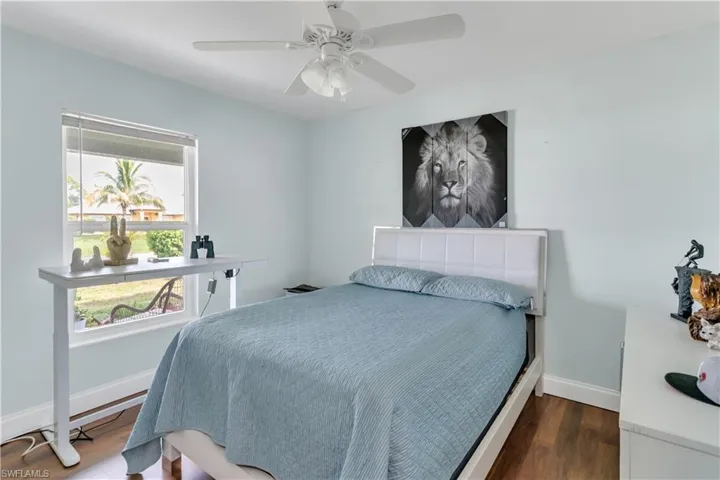 Bedroom featuring ceiling fan and hardwood / wood-style flooring