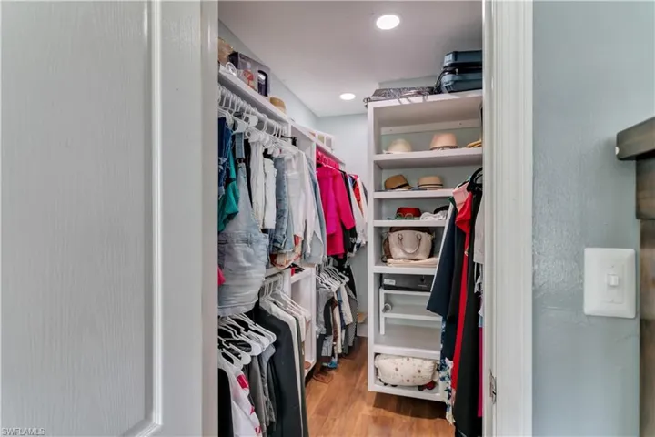 Spacious closet in master with hardwood / wood-style floors