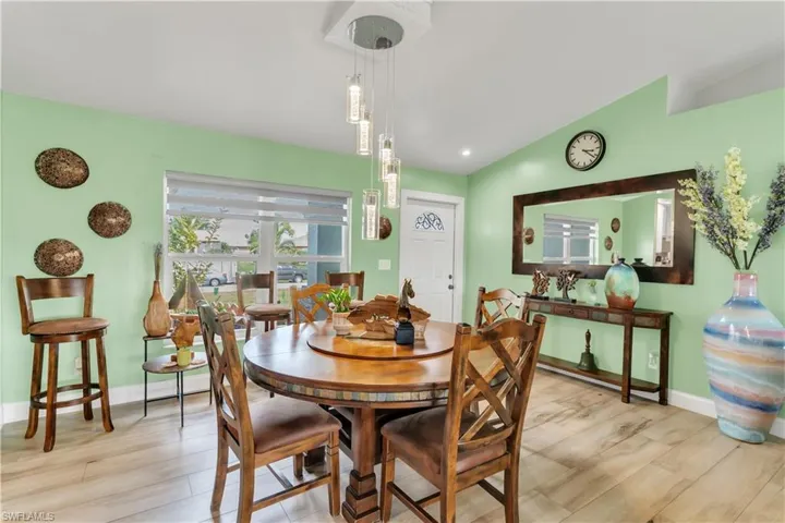 Dining room featuring vaulted ceiling and light hardwood / wood-style floors