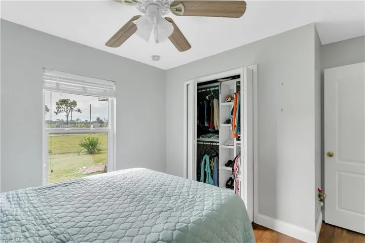 Bedroom featuring hardwood / wood-style flooring, a closet, and ceiling fan