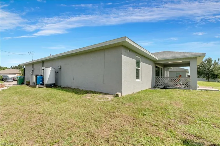 View of side of home with a yard