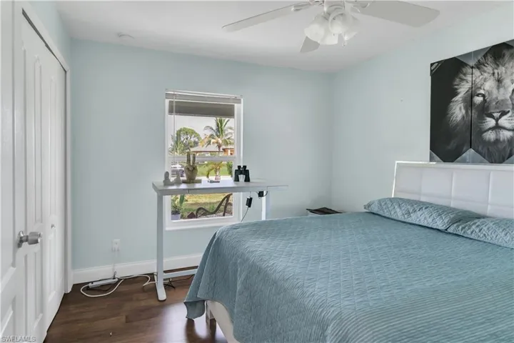 Bedroom featuring hardwood / wood-style floors, ceiling fan, and a closet