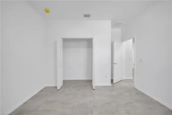 Unfurnished bedroom with baseboards and a closet