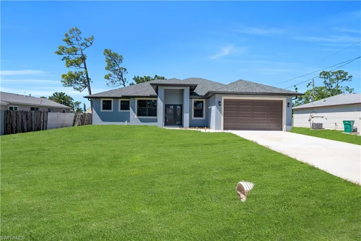 Prairie-style home with stucco siding, roof with shingles, concrete driveway, and a garage