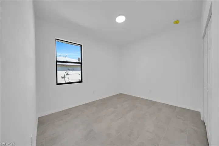 Unfurnished room featuring baseboards and light tile patterned floors