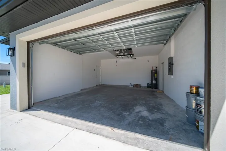 Garage with electric water heater and electric panel
