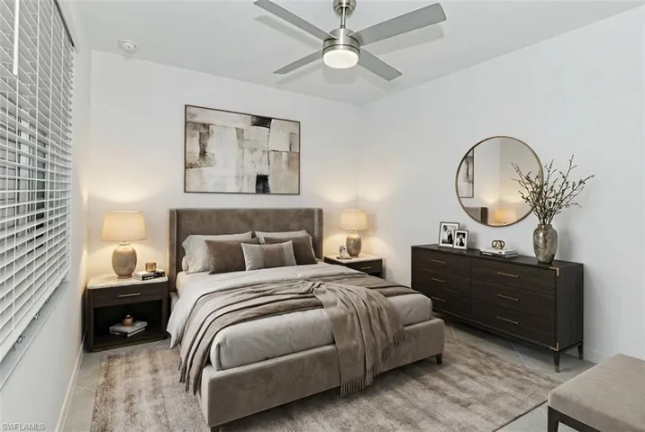 Bedroom with ceiling fan and baseboards