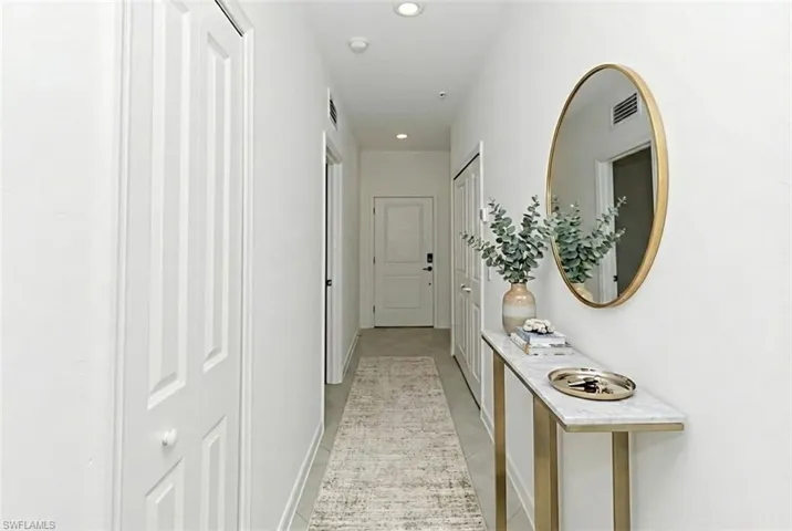 Hallway featuring recessed lighting and baseboards