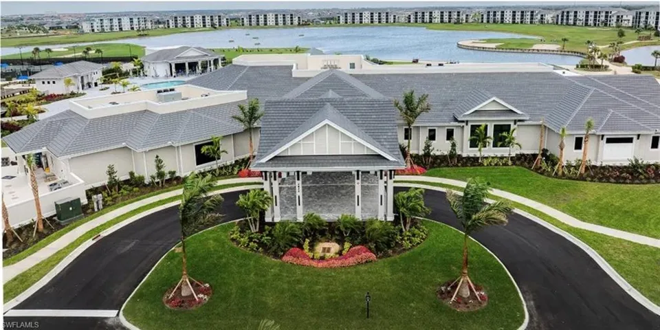 Drone / aerial view of a large body of water and apartment complex / building