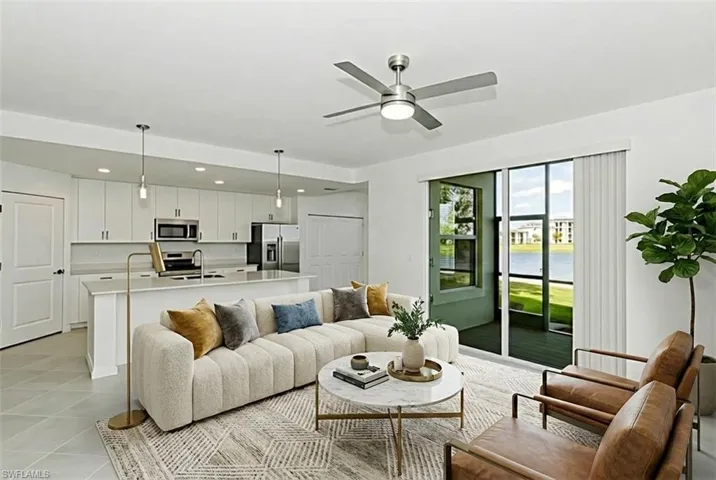 Living room with a water view and ceiling fan
