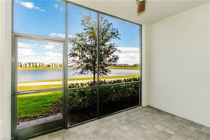 Unfurnished sunroom featuring a water view and ceiling fan
