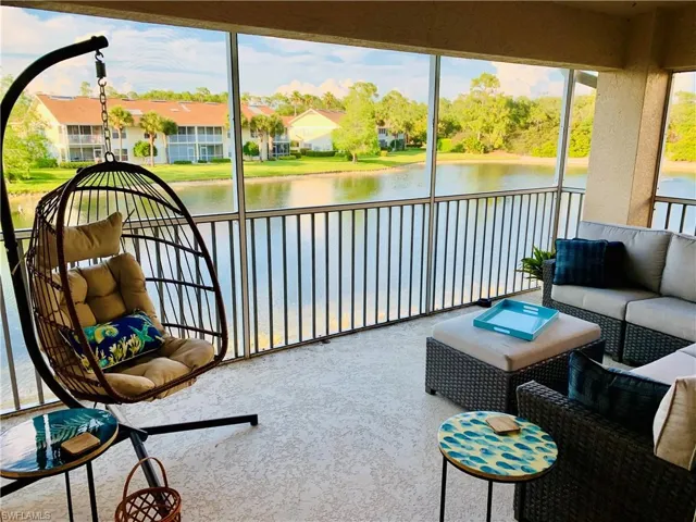 Sunroom featuring outdoor lounge area and a water view