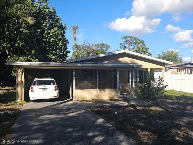 View of front facade featuring a carport, a sunroom, and driveway